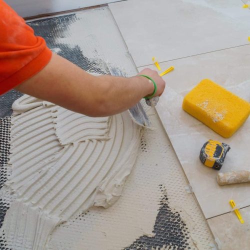 Applying new tiles on bathroom floor tile installation for house building